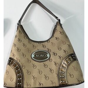 XOXO monogram canvas and faux leather shoulder bag with stud accents.